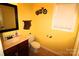 Bathroom featuring a sink with wood cabinets, a toilet, vinyl flooring and a window at 1256 Twin Lakes Rd, Rock Hill, SC 29732