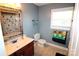 Cozy bathroom with single sink, wood cabinets, vinyl flooring and a window for natural light at 1256 Twin Lakes Rd, Rock Hill, SC 29732