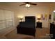 This bedroom has neutral-colored walls and carpet, as well as a ceiling fan and comfortable furnishings at 1256 Twin Lakes Rd, Rock Hill, SC 29732