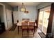 Cozy dining area with a stylish light fixture, wood table, and sliding glass door to the outside at 1256 Twin Lakes Rd, Rock Hill, SC 29732