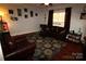 Cozy living room with a comfortable sofa, warm wood floors, and natural light streaming through the windows at 1256 Twin Lakes Rd, Rock Hill, SC 29732