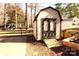 Charming storage shed with a ramp, nestled in a well-maintained backyard with manicured beds at 1256 Twin Lakes Rd, Rock Hill, SC 29732