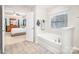 Bright bathroom featuring a large soaking tub, stand up shower, and double sink vanity at 128 Millen Dr, Mooresville, NC 28115