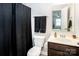 Modern bathroom with a dark wood vanity, dark colored towels and shower curtain, and a toilet at 128 Millen Dr, Mooresville, NC 28115