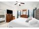 A spacious primary bedroom has carpet floors, a ceiling fan, nice furniture and natural light from windows at 128 Millen Dr, Mooresville, NC 28115