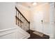 Inviting entryway with dark wood floors and staircase, and white paneled walls at 128 Millen Dr, Mooresville, NC 28115