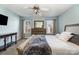 Bright bedroom with a ceiling fan, dresser with mirror, and light blue walls at 151 Birkdale Dr, Salisbury, NC 28144