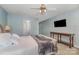 Brightly painted bedroom with ceiling fan, console table, TV, and doorway at 151 Birkdale Dr, Salisbury, NC 28144