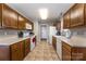 Efficient kitchen with wood cabinets, white appliances, and tile flooring at 151 Birkdale Dr, Salisbury, NC 28144