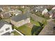 Aerial view of backyard and neighborhood with lush landscaping and a brick patio at 15138 Callow Forest Dr, Charlotte, NC 28273