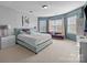 Bright bedroom with a large bed, sitting area, and ample natural light at 15138 Callow Forest Dr, Charlotte, NC 28273