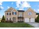 Stunning two-story brick home featuring a manicured lawn and a two-car garage at 15138 Callow Forest Dr, Charlotte, NC 28273