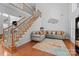 Welcoming foyer with hardwood floors, staircase, and a cozy seating area at 15138 Callow Forest Dr, Charlotte, NC 28273