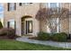 A brick front entrance with a black front door and manicured lawn at 15138 Callow Forest Dr, Charlotte, NC 28273