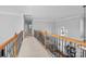 Upstairs hallway with decorative wrought iron handrail overlooking the living room at 15138 Callow Forest Dr, Charlotte, NC 28273
