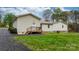 Home backyard featuring back entrance, stone foundation, and healthy lawn at 1514 Ring Tail Rd, Claremont, NC 28610