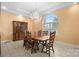 Bright dining room showcasing a large window, chandelier lighting and an adjacent china cabinet at 1514 Ring Tail Rd, Claremont, NC 28610