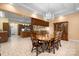 Elegant dining room with tile floors, chandelier lighting, and an open view to the kitchen at 1514 Ring Tail Rd, Claremont, NC 28610