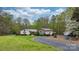 Beautiful single Gathering home featuring stone accents, metal roof, and long gravel driveway at 1514 Ring Tail Rd, Claremont, NC 28610