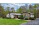 Beautiful ranch home with stone and siding details, a metal roof, and well-kept landscaping at 1514 Ring Tail Rd, Claremont, NC 28610