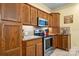 Close-up of the kitchen with wooden cabinets and stainless steel appliances at 1514 Ring Tail Rd, Claremont, NC 28610