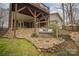 Inviting backyard showcasing a charming swing and landscaped retaining wall, perfect for relaxation and outdoor enjoyment at 15920 Fieldstone Dr, Matthews, NC 28104
