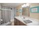 Bathroom features a vanity with a sink, framed mirror, and a shower with a chevron curtain at 15920 Fieldstone Dr, Matthews, NC 28104