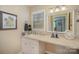Bright bathroom with a vanity, mirror, drawers, and a window with blinds at 15920 Fieldstone Dr, Matthews, NC 28104