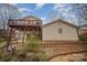 Exterior view of a two story home featuring a unique balcony and backyard landscape at 15920 Fieldstone Dr, Matthews, NC 28104