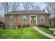 Charming brick home features a well-manicured lawn and vibrant green shutters, offering classic curb appeal at 15920 Fieldstone Dr, Matthews, NC 28104