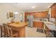 Well-lit kitchen boasting stainless steel appliances, wooden cabinets, and a breakfast bar with seating at 15920 Fieldstone Dr, Matthews, NC 28104