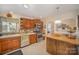 Spacious kitchen featuring wooden cabinets, stainless steel appliances, and an open layout with a view to the dining area at 15920 Fieldstone Dr, Matthews, NC 28104