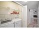 Convenient laundry room features appliances and shelving for storage at 15920 Fieldstone Dr, Matthews, NC 28104
