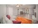 Open-concept living room with hardwood floors, bar area, fireplace, ceiling fans and patio doors at 15920 Fieldstone Dr, Matthews, NC 28104