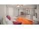 Open-concept living room with hardwood floors, bar area, fireplace, ceiling fans and patio doors at 15920 Fieldstone Dr, Matthews, NC 28104