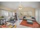 Bright sunroom with exercise equipment, tile floors, a ceiling fan, and patio access, ideal for wellness at 15920 Fieldstone Dr, Matthews, NC 28104