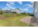 This spacious backyard features a well-maintained lawn, paver patio and a secure black metal fence at 1766 Loggerhead Dr, Lancaster, SC 29720