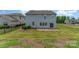 Large backyard featuring a well-maintained lawn, paver patio, and secure black metal fence at 1766 Loggerhead Dr, Lancaster, SC 29720