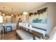 Open-concept dining area features a table with bench, modern art and kitchen bar access at 1766 Loggerhead Dr, Lancaster, SC 29720