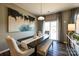 Modern dining room with a dark wood table, bench seating, neutral walls, and large abstract art at 1766 Loggerhead Dr, Lancaster, SC 29720