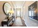 Warm foyer with wood floors, a console table with décor, and neutral paint color scheme at 1766 Loggerhead Dr, Lancaster, SC 29720