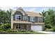 New two-story home featuring stone accents, an attached two-car garage, and a landscaped front yard at 1766 Loggerhead Dr, Lancaster, SC 29720