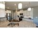Bright kitchen with stainless steel appliances, granite countertops, white cabinetry and breakfast bar at 1766 Loggerhead Dr, Lancaster, SC 29720