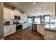 Bright kitchen features white cabinets, stainless steel appliances, granite countertops and stylish pendant lighting at 1766 Loggerhead Dr, Lancaster, SC 29720