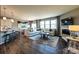 Open-concept living room and kitchen, hardwood flooring, fireplace, and large windows at 1766 Loggerhead Dr, Lancaster, SC 29720