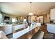Open concept living and dining area with hardwood floors, neutral paint, kitchen and staircase in view at 1766 Loggerhead Dr, Lancaster, SC 29720