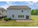 Rear exterior with large windows and sliding glass door leading to a paver patio at 1766 Loggerhead Dr, Lancaster, SC 29720