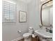 Bathroom featuring a toilet, sink, window with shutter, a gold framed mirror, and a beaded light fixture at 2013 Garden View Ln, Weddington, NC 28104
