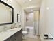 Bathroom featuring dark vanity, neutral finishes, and shower-tub combination at 2013 Garden View Ln, Weddington, NC 28104