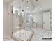 Bright bathroom featuring a glass shower, white marble floors, and a vanity with double sinks at 2013 Garden View Ln, Weddington, NC 28104